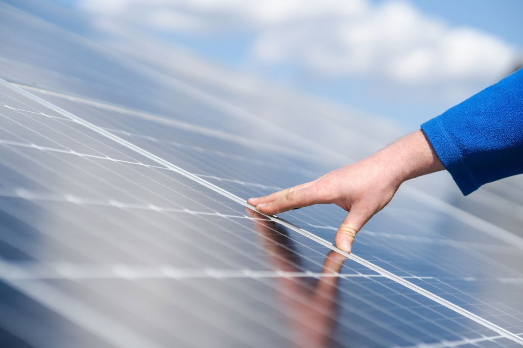 engineer-s-hand-on-solar-panel.jpg
