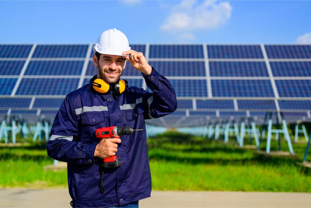 engineer-worker-portrait-with-solar-panel-at-solar-farm-1.jpg