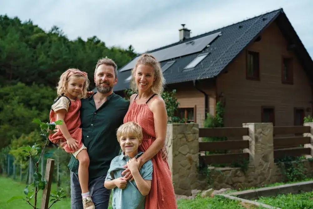 happy-family-near-their-house-with-solar-panels-alternative-energy-saving-resources-and.webp